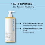 Un flacon de Nuhanciam Gel Douche Douceur Sans Savon 500 ml avec une pompe est représenté sur un fond bleu, mettant en avant sa formule hydratante à base de plantes et ses bienfaits de nettoyage doux sans savon. Dakar