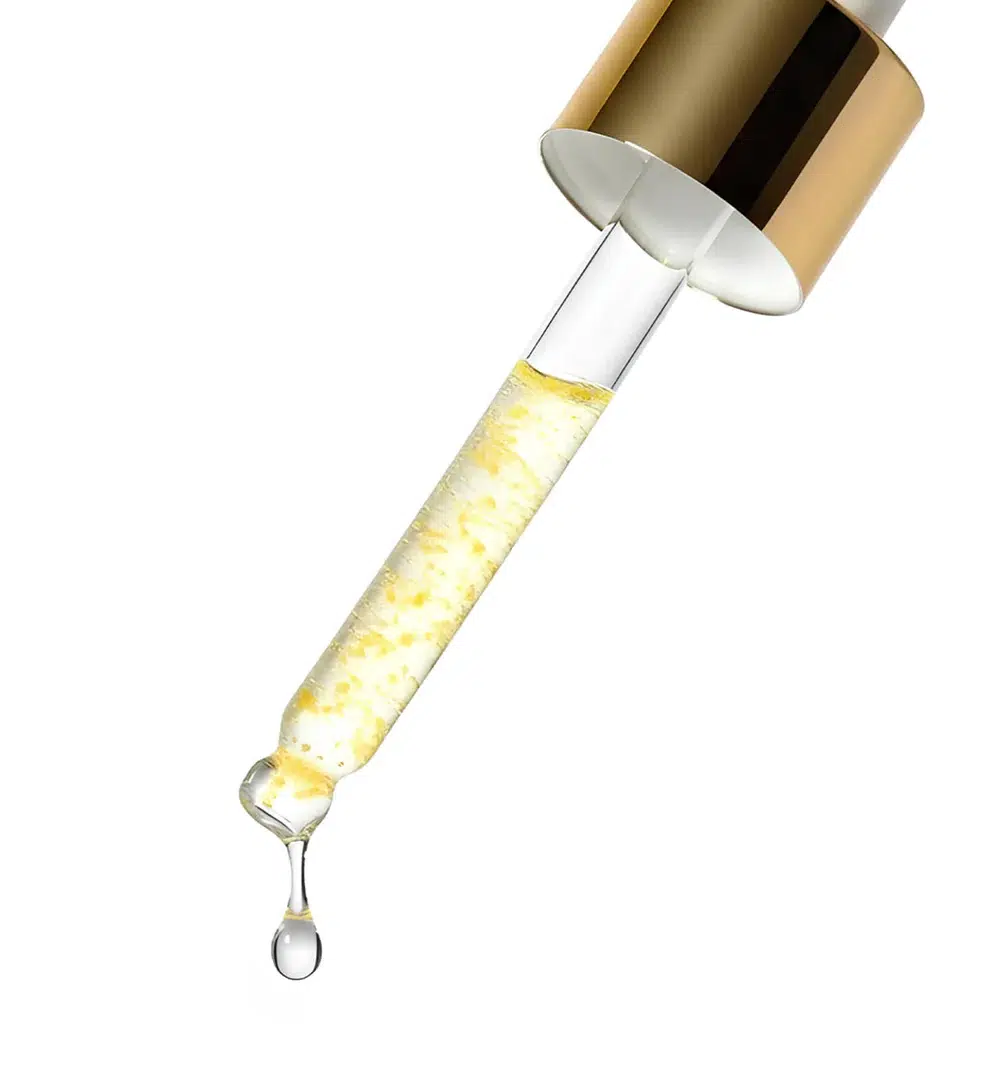 Un compte-gouttes en verre à bouchon doré distribue Medicube Deep Vita C Sérum Capsule Illuminateur Anti Tache 30 ml, un sérum transparent avec des particules jaunâtres, avec une goutte prête à tomber sur un fond blanc. Dakar