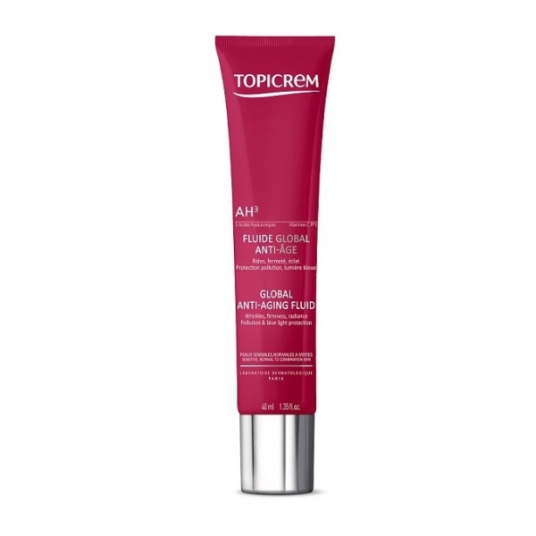 Un tube rouge de Topicrem AH3 Fluide Global Éclat Anti-Âge 40 ml avec un texte blanc se tient debout sur un fond blanc. Dakar