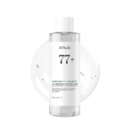 Un flacon transparent de Anua Heartleaf Tonique Apaisant 77% Anti Acné 250ml avec un bouchon blanc et une étiquette minimaliste est représenté sur un fond présentant une texture de gel clair. Dakar