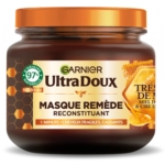 Un pot de 300 ml de Garnier Masque Reconstituant Trésors de Miel - Ultra Doux pour cheveux fragiles et cassants, avec des visuels de nid d'abeille et de miel sur l'étiquette et 97% d'ingrédients d'origine naturelle. Dakar