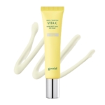 On voit un tube jaune de « Goodal Crème Anti-Cernes pour les Yeux Vita C à la Mandarine Verte » de 30 ml, muni d'un bouchon argenté, avec en arrière-plan une touche artistique de crème étalée. Dakar