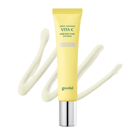 On voit un tube jaune de « Goodal Crème Anti-Cernes pour les Yeux Vita C à la Mandarine Verte » de 30 ml, muni d'un bouchon argenté, avec en arrière-plan une touche artistique de crème étalée. Dakar