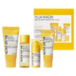 Le « Some By Mi Yuja Niacin 30 Days Brightening Kit Débutant Pour une peau Lumineuse » comprend quatre élégants flacons et tubes jaunes et blancs de différentes tailles, chacun détaillé avec les ingrédients et l'utilisation, magnifiquement complétés par la boîte Some By Mi Yuja en arrière-plan. Dakar