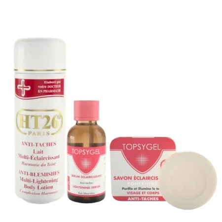 Trois produits de soin du HT26 Trio Éclaircissant Anti Taches : un grand flacon blanc et or "HT26 Paris", un petit "TOPSYGEL Lightening Serum" marron, et un savon rond blanc dans une boîte rose "TOPSYGEL". Dakar