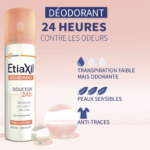 Le Déodorant ETIAXIL 48H Douceur 150 ml est représenté sur un fond rose clair avec du texte et des icônes en français, mettant en avant la protection contre les odeurs pendant 48 heures, les caractéristiques anti-taches et le soin doux pour les peaux sensibles. Dakar