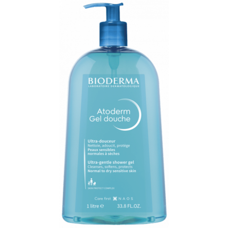 Un flacon pompe bleu de Bioderma ATODERM Gel Douche Nettoyant Douceur 1L, parfait pour la chaleur du Dakar. L'étiquette le décrit comme un gel douche ultra-doux adapté aux peaux sensibles normales à sèches. Dakar