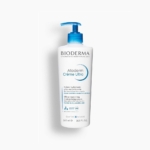 Un flacon blanc de 500 ml de Bioderma Atoderm Crème ultra-nourrissante avec une pompe bleue et un texte bleu/noir, décrit comme un hydratant ultra-nourrissant pour les peaux sensibles normales à sèches. Dakar