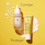 Deux produits de soin Caudalie sont présentés sur un fond jaune : un flacon de « Coffret Vinoperfect Sérum Éclat Anti-Taches » Caudalie de 30 ml, sur lequel on distingue des gouttelettes, et un tube de « Vinosun Protect Fluide SPF50+ » de 20 ml (offert), à côté duquel on voit de la crème étalée. Les mots « Corriger » et « Protéger » apparaissent sur l'image. Dakar