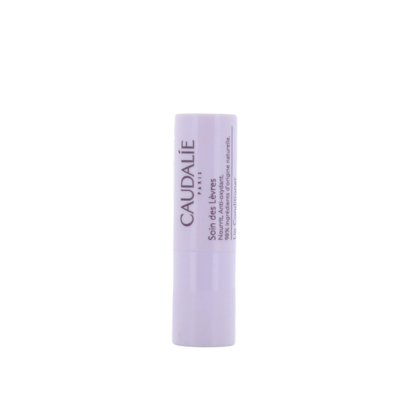 Un tube blanc de Caudalie - Soin des lèvres 4,5 g se tient debout sur un fond blanc uni, avec le nom et les détails du produit imprimés verticalement en violet sur le tube. Dakar