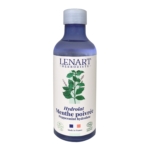 Un flacon bleu de 200 ml étiqueté "Christian Lenart Lotion Soin Matifiante Menthe Poivrée", avec une illustration d'une plante de menthe et un texte français, anglais et de certification biologique sur l'étiquette blanche. Dakar