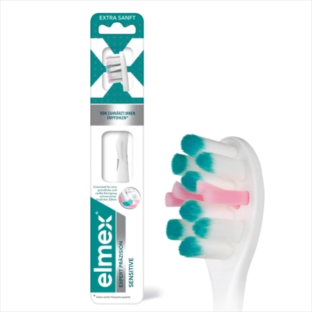 Gros plan sur la brosse à dents blanche Elmex Brosse A Dents Sensible Professionnelle Extra Douce 1 Pc avec des poils extra souples, à côté de son emballage principalement blanc et sarcelle affichant des informations sur le produit et une étiquette "recommandé par les dentistes". Dakar