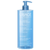 Un flacon bleu de Uriage Gel Douche Surgras Dermatologique Peaux Sensibles 500 ml avec une pompe