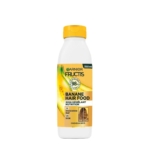 Un flacon blanc et jaune de 350 ml de Garnier Fructis Hair Food Après shampooing à la Banane pour cheveux secs, avec un bouchon jaune, des graphismes de banane et des informations sur le produit en français sur l'étiquette avant. Dakar