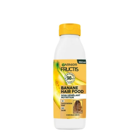 Un flacon blanc et jaune de 350 ml de Garnier Fructis Hair Food Après shampooing à la Banane pour cheveux secs, avec un bouchon jaune, des graphismes de banane et des informations sur le produit en français sur l'étiquette avant. Dakar