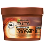 Un contenant de 400 ml de Garnier Fructis Hair Food Masque Multi Usages à la Macadamia pour les cheveux secs et indisciplinés, avec un emballage orange et marron étiqueté en Allemagne avec les détails du produit. Dakar
