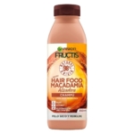 Un flacon de 400 ml de Garnier Fructis Shampooing Hair Food Macadamia pour les cheveux secs et indisciplinés, avec un bouchon marron et une étiquette orange avec les détails et les avantages du produit en espagnol. Dakar