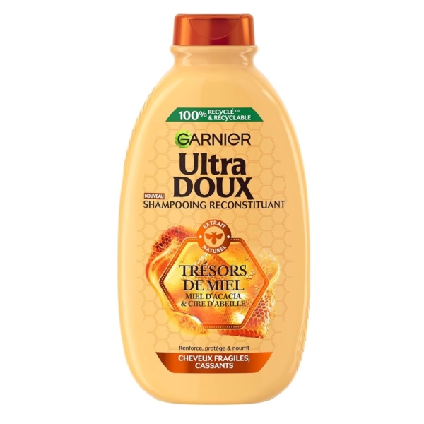 Un flacon de GARNIER Shampoing Reconstituant Trésors de Miel 600 ml au miel d'acacia et à la cire d'abeille