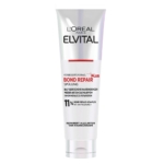 Un tube blanc de L'Oréal ElvitalL Après Shampoing Réparateur Cheveux Abîmés 150 ml, avec un texte allemand noir et rouge soulignant ses avantages, se tient debout sur un fond blanc. Dakar