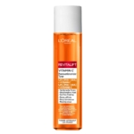 Un flacon de 180 ml de L'Oréal Lotion Tonique Exfoliante et Purifiante à la Vitamine C Revitalift Teint Terne et Réducteur Pores, avec un bouchon blanc et une étiquette orange, connu pour éclaircir la peau et réduire les pores. Dakar