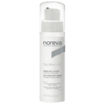 Flacon blanc de Noreva Trio White XP Sérum Éclat Correcteur Anti-Taches 30 ml avec un texte détaillant son objectif en français et en anglais