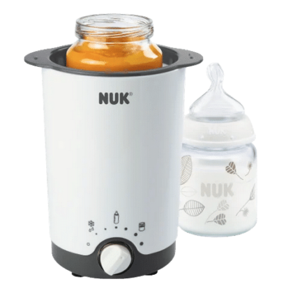 Un Biberon 3 en 1 Nuk Thermo Chauffe blanc avec un pot de nourriture pour bébé à l'intérieur et un biberon avec un motif de feuille à côté