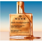 Un flacon de 100 ml d'Huile Prodigieuse Or de Nuxe sur lequel coule un filet d'huile dorée