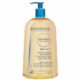 L'Huile De Douche Bioderma ATODERM 1L est un flacon transparent avec pompe bleue disponible à Dakar. L'étiquette affiche un texte en français et en anglais, soulignant ses bienfaits ultra-nourrissants et anti-irritants pour les peaux très sèches et sensibles. Dakar