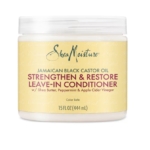 Un pot de Shea Moisture Huile de Ricin Jamaican Black Castor Oil Leave In 454g (Sans Rinçage), avec du beurre de karité, de la menthe poivrée et du vinaigre de cidre de pomme pour un soin capillaire nourrissant. Dakar