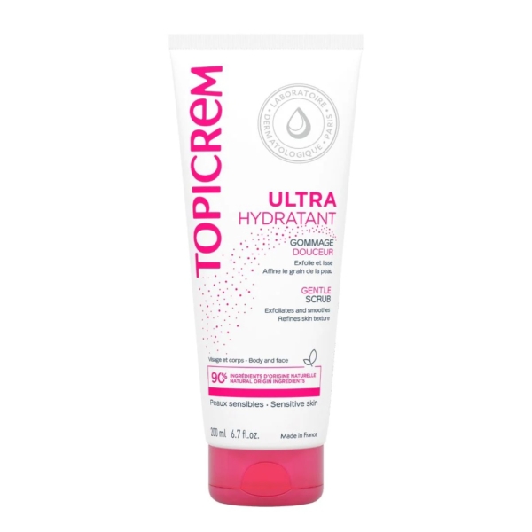 Tube blanc de 200 ml de Topicrem Gommage Douceur, pour peaux sensibles, avec inscription rose et grise et bouchon à clapet rose. Fabriqué en France, il exfolie et lisse la peau en douceur. Dakar