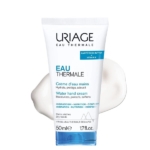 L'Uriage EAU THERMALE - Crème d'Eau Mains Sèches, en tube blanc de 50 ml, se présente sur un fond crème. Son packaging met en avant le beurre de karité et la vitamine E, avec un texte mettant en avant l'hydratation, la nutrition et le confort apaisant propre à Uriage Eau Thermale. Dakar