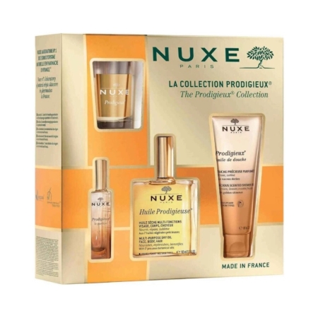 Nuxe Coffret L'Infiniment Glow Visage Corps Cheveux et Lèvres est un coffret cadeau composé de trois flacons et d'un tube dans un emballage or et beige, portant la mention "Made in France". Dakar