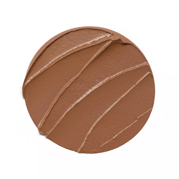 Une couche lisse et ronde de maquillage Essence Baby Got Bronze Bronzing Stick Bronzeur 5,5 g orne la surface, sa teinte brun crémeux rehaussée de stries d'application visibles. Dakar