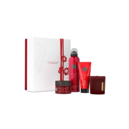 Un coffret blanc aux accents rouges est placé à côté de quatre produits Rituals Le Rituel de l'Ayurveda Grand Set 2024 - un pot, un flacon, un tube et une bougie - tous ornés d'élégants motifs floraux. Dakar