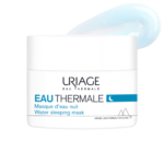 Un pot de 50 ml de Masque de Nuit Eau Thermale d'Uriage à la texture crémeuse bleue. L'emballage majoritairement blanc présente des touches de bleu et du texte en français et en anglais. Dakar