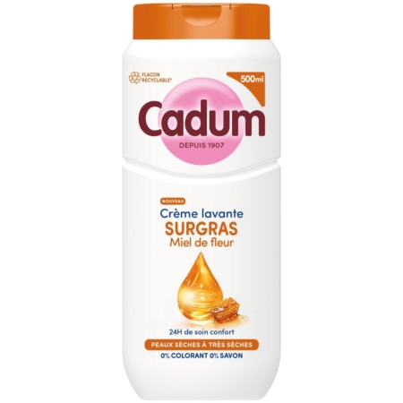 Un flacon de 500ml de Cadum Crème Lavante Surgras Miel de Fleurs, avec un design blanc et orange avec des images de miel. L'étiquette met en avant le confort 24H pour les peaux sèches, et la formule est sans savon ni colorant. Dakar