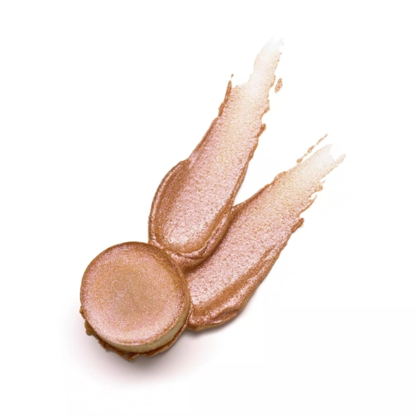 Découvrez l'Essence Stick Illuminateur BABY GOT HOLO GLOW Highlighter, un essentiel scintillant en or rose dans un contenant circulaire avec deux touches ludiques ressemblant à des oreilles. Le produit brille d'une finition métallique brillante sur un fond blanc immaculé. Dakar