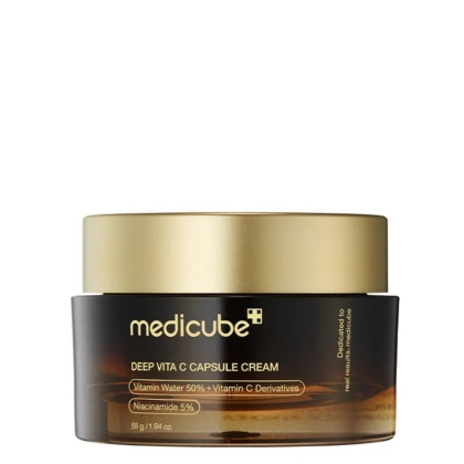 Un élégant pot de 55 g de Medicube Crème Deep Vita C Clarifiant, doté d'un couvercle doré et d'un contenant marron avec inscription blanche et dorée. Contient notamment 50 % d'eau vitaminée, des dérivés de vitamine C et 5 % de niacinamide. Dakar