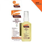 Un flacon et une boîte de Palmers Skin Therapy Oil - Huile réparatrice pour le corps 150 ml mettent en valeur les bienfaits pour les cicatrices, les vergetures et la peau sèche. L'emballage comprend un distributeur à pompe sur fond blanc avec le logo Lumi Beauty. Dakar