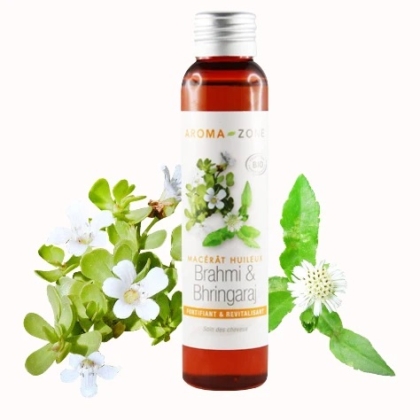 Une bouteille brune étiquetée « Aroma Zone Huile de Brahmi et Bhringaraj BIO » se dresse au milieu de feuilles et de fleurs luxuriantes de Brahmi et de Bhringaraj, aux côtés d'Aroma Zone Huile de Moutarde BIO, promettant une expérience d'huile fortifiante et revitalisante. Dakar