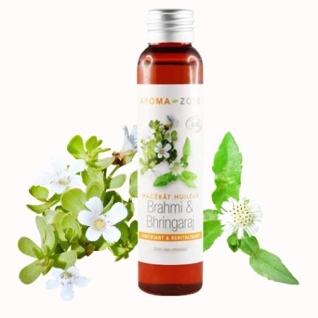 Une bouteille brune étiquetée « Aroma Zone Huile de Brahmi et Bhringaraj BIO » se dresse au milieu de feuilles et de fleurs luxuriantes de Brahmi et de Bhringaraj, aux côtés d'Aroma Zone Huile de Moutarde BIO, promettant une expérience d'huile fortifiante et revitalisante. Dakar
