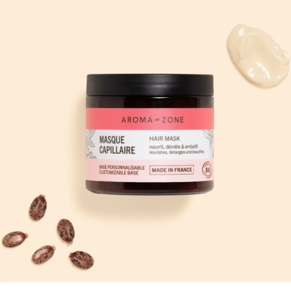 Un pot de 200 ml de Masque capillaire Aroma Zone Base repose sur une surface crémeuse, avec des graines de ricin et une noisette de masque nourrissant et démêlant à proximité. Sublimez votre routine capillaire avec le Sérum cheveux anti-chute Aroma Zone pour plus de force et de beauté, fabriqué en France. Dakar