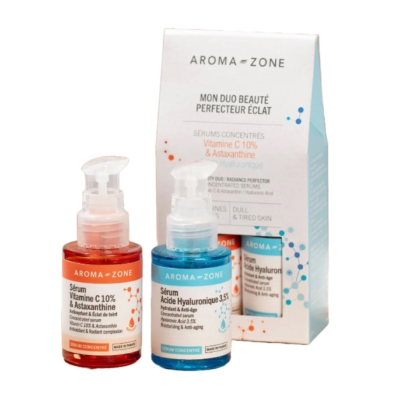 Le Coffret duo sérums Aroma Zone - Éclat de la peau se compose de deux flacons : un rouge avec 10% de Vitamine C et Astaxanthine, et un bleu enrichi avec 3,5% de Sérum concentré d'Acide hyaluronique, le tout présenté dans un packaging blanc épuré affichant les détails essentiels. Dakar