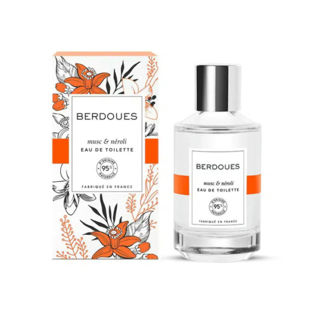 Un flacon d'Eau de Toilette Berdoues Muse & Néroli est présenté devant son coffret. Ce dernier présente des motifs floraux orange et noirs. L'étiquette indique que l'eau est 95 % naturelle et fabriquée en France. Le flacon contient un liquide transparent. Dakar