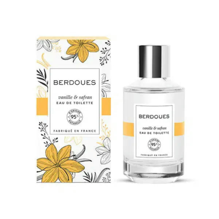 Un flacon de parfum étiqueté « Eau de Toilette Berdoues Vanille & Safran » est présenté à côté de son coffret assorti. Ce dernier est orné d'illustrations florales jaunes et noires. Les deux articles portent l'étiquette « 95 % d'origine naturelle ». Dakar