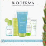 Un coffret cadeau Bioderma comprenant Sébium Gel Moussant, Sébium Lotion, Sébium Global, Sébium Mat Control et une petite Eau Micellaire Sébium H2O. Le coffret est orné de décorations festives à base de feuillage vert et de baies rouges. Dakar