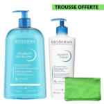 Un grand flacon de Gel Nettoyant Doux Bioderma Atoderm et un plus petit flacon de Crème Ultra-Nourrissante Atoderm, accompagnés d'un gant de toilette vert. L'étiquette indique « Trousse Offerte » en haut à droite. Dakar