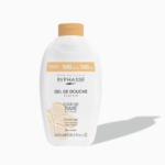 Un flacon de gel douche Byphasse, étiqueté « Gel de Douche Plaisir » et orné de « Fleur de Tiaré de Tahiti ». L'emballage est blanc avec des inscriptions dorées et noires, et contient 600 ml. Dakar