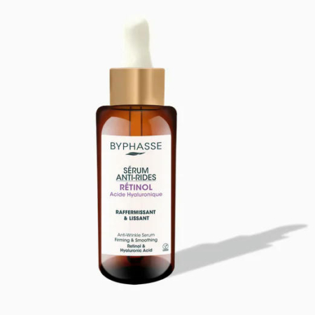 Un flacon de sérum anti-rides au rétinol et à l'acide hyaluronique Byphasse. Le flacon ambré foncé est doté d'un bouchon compte-gouttes et d'une étiquette blanche décrivant le produit comme raffermissant et lissant. Des ombres sont visibles sur le fond blanc. Dakar