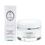 Un pot blanc de crème visage et mains Candès Éclat se trouve à côté de sa boîte blanche assortie. La boîte porte l'inscription « Sérum Clarifiant et Correcteur » et arbore le logo Candès Paris sur le dessus. Dakar